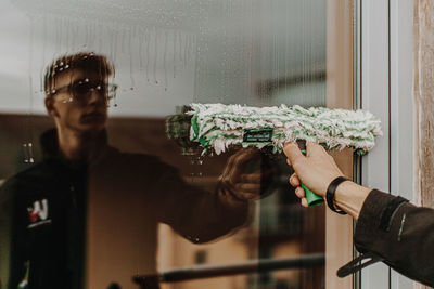 Man photographing through glass window