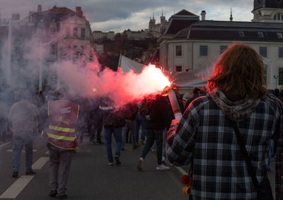 Person with a smoke bomb during a demonstration in france