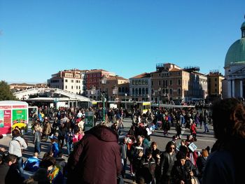 People in city against clear sky