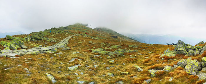 Scenic view of mountains against cloudy sky