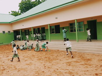 Boy playing in front of building