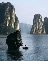 Rock formations in sea against sky