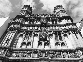 Low angle view of ornate building against cloudy sky