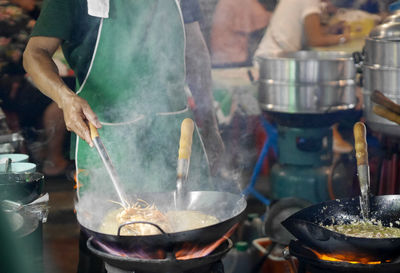 Panoramic shot of people in cooking pan