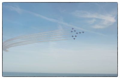 Low angle view of airplane flying against sky