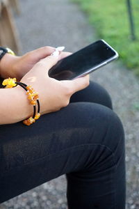 Midsection of man using mobile phone