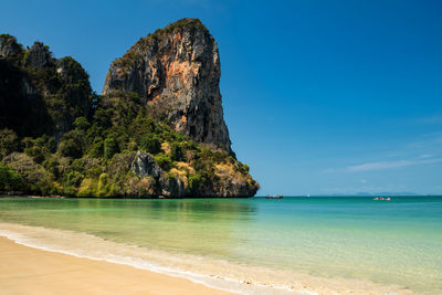 Scenic view of sea against blue sky at railay beach