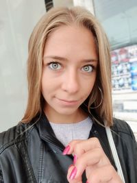 Close-up portrait of smiling beautiful woman with blond hair