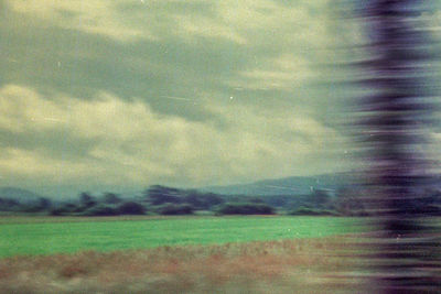 Defocused image of field against sky