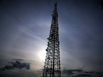 Low angle view of communications tower against sky during sunset