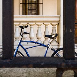 Bicycle on railing against building