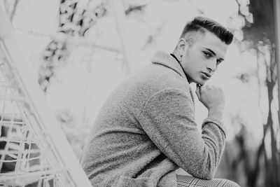 Portrait of young man sitting outdoors