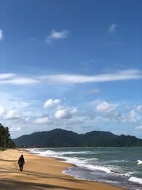 Man on beach against sky