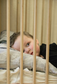 Portrait of cute baby lying on bed