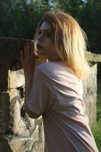 Side view of young woman drinking outdoors