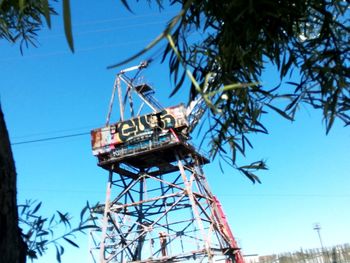 Low angle view of communications tower against clear blue sky