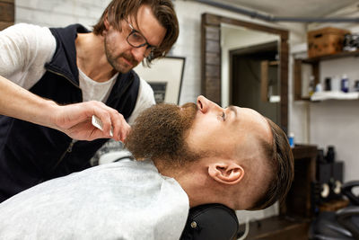 Side view of senior man working at home