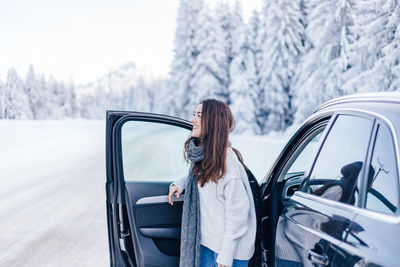 Rear view of woman holding car