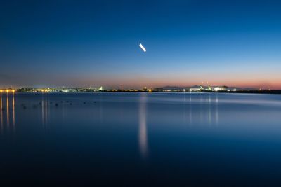 Scenic view of sea against blue sky at night