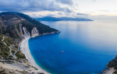 High angle view of sea and mountains against sky