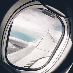 Close-up of airplane wing against the sky