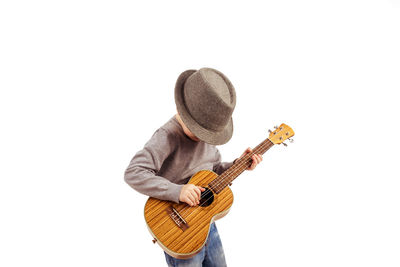 Full length of man playing guitar against white background