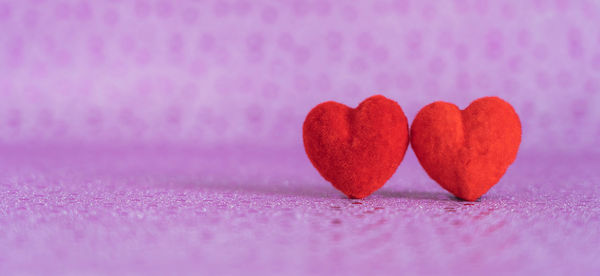 Close-up of heart shape on pink table