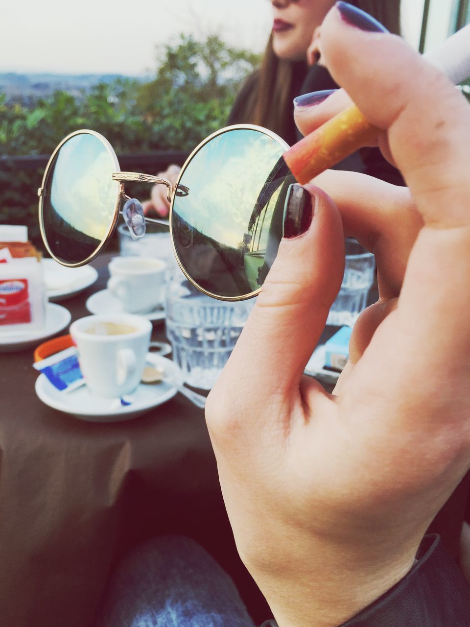 person, holding, food and drink, drink, part of, refreshment, lifestyles, cropped, leisure activity, freshness, close-up, focus on foreground, technology, coffee cup, table, coffee - drink, human finger