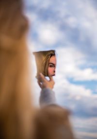 Portrait of woman against sky