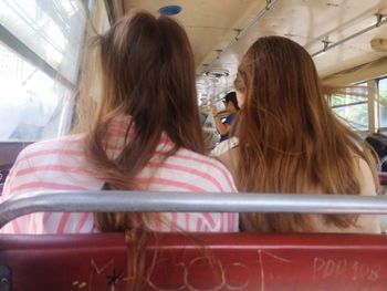 Rear view of woman sitting in train