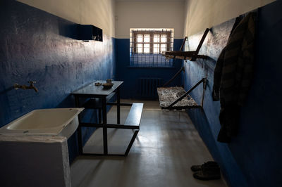 Empty chairs and table against wall at home