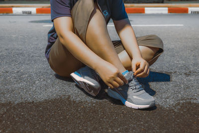 People sit and tie their shoelaces to exercise.