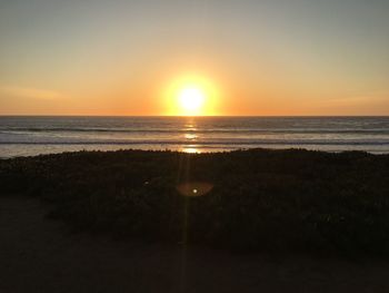 Scenic view of sea against sky at sunset