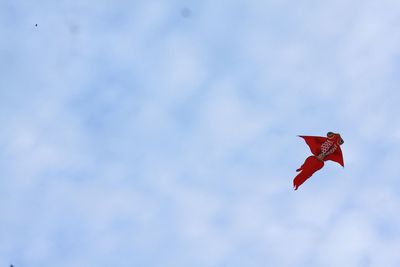 Low angle view of kite flying against sky