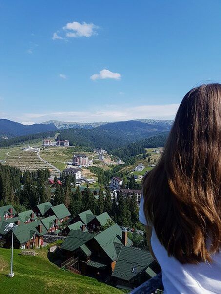 mountain, rear view, mountain range, landscape, outdoors, building exterior, tranquility, scenics, adult, architecture, women, people, clear sky, only women, nature, sky, adults only, summer, built structure, day, lake, photography themes, one woman only, vacations, beauty in nature, one person, cityscape, young adult