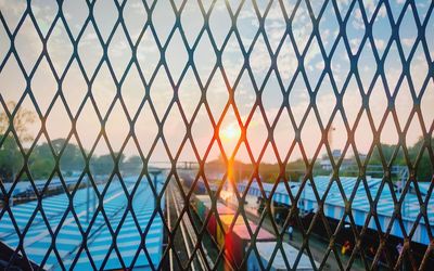 Chainlink fence against sky at the railway station