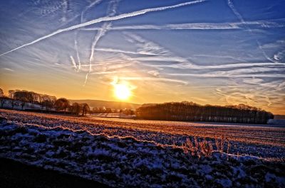 Scenic view of snow against sky during sunset