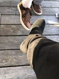 Low section of woman standing on boardwalk
