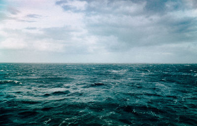 Scenic view of sea against cloudy sky