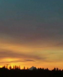 Scenic view of silhouette landscape against sky at sunset