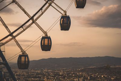 Overhead cable cars against sky at sunset