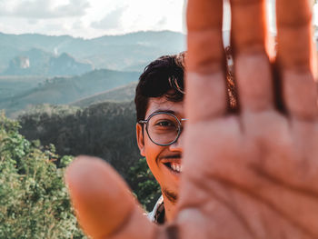 Low angle view of young man wearing sunglasses