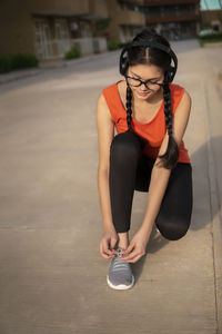 Portrait of young woman standing on road