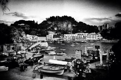 Boats in river with buildings in background