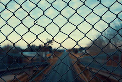 Urban city landscape through a wired fence