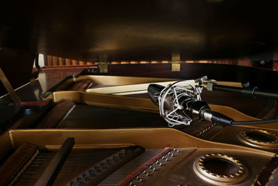 Close-up of microphone by piano at recording studio