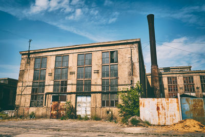 Low angle view of abandoned building against sky