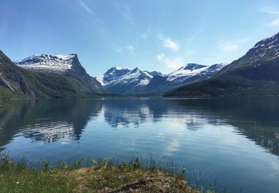 Scenic view of lake and mountains against sky