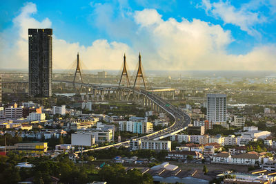 High angle view of city buildings against cloudy sky