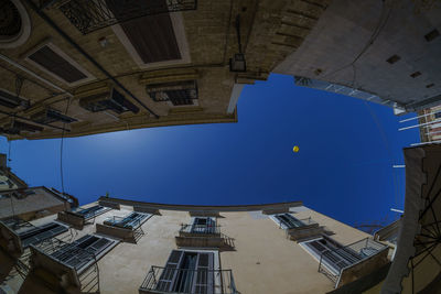 Fish eye view of residential buildings against sky